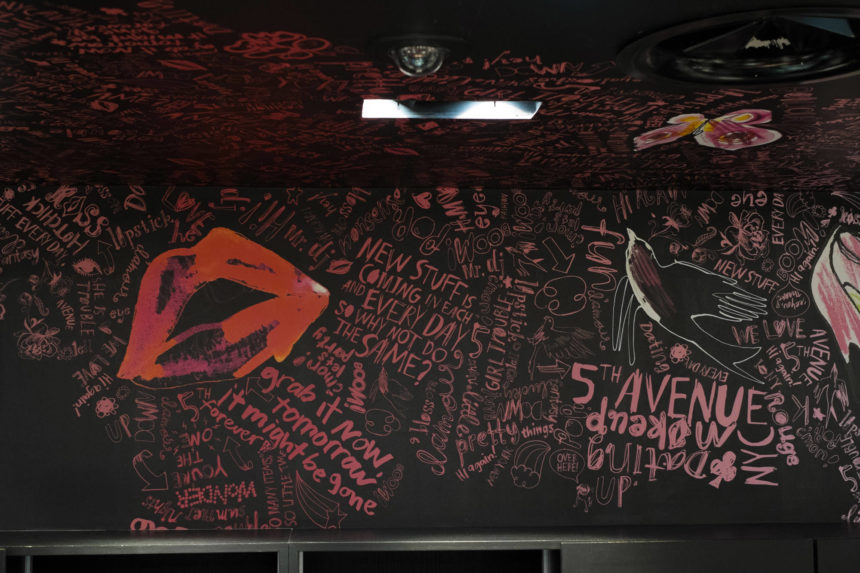 H&M black wall with red and pink text by Lovisa Burfitt