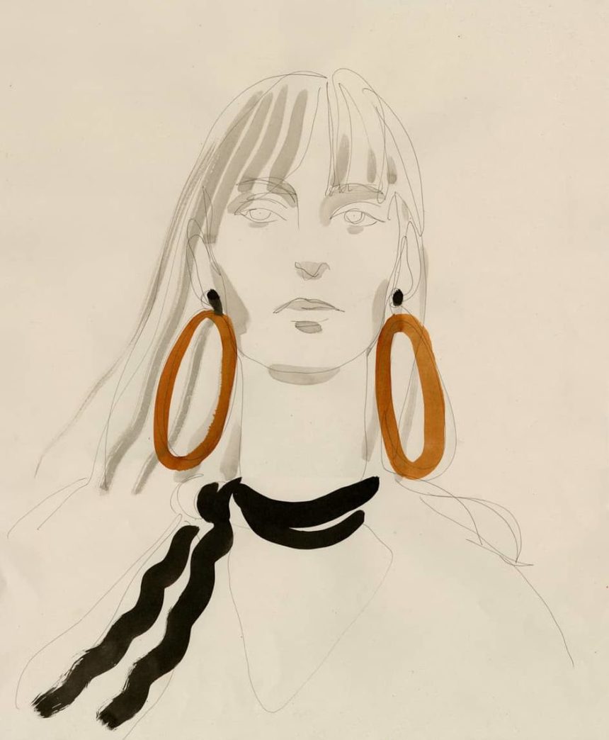 Portrait of woman wearing brown earrings.